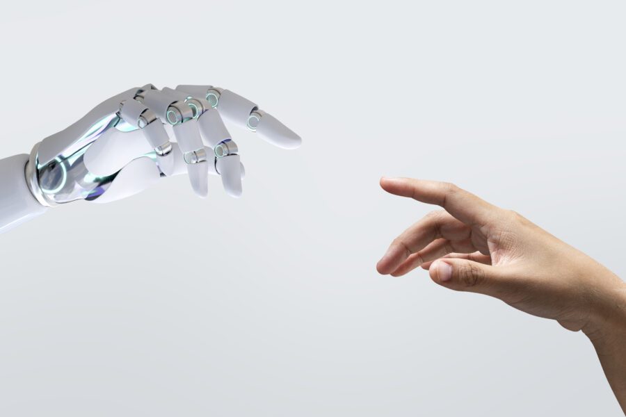 Intelligenza artificiale: mano umano e mano robotica che si sfiorano